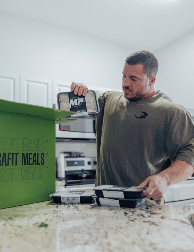 Athlete Brett Wilkin with MegaFit Meals Boxes